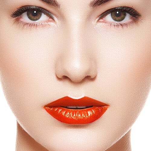 Model wearing a bold orange lipstick