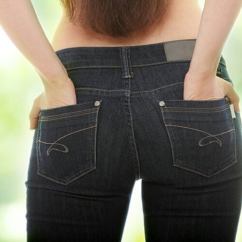 Woman checking her curves after a Brazilian butt lift.