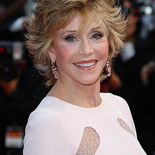 Smiling woman considering facial rejuvenation treatments.
