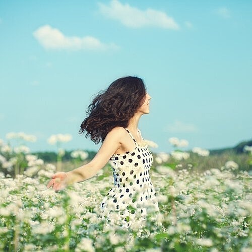 Woman enjoying gentle sunlight after facial rejuvenation.