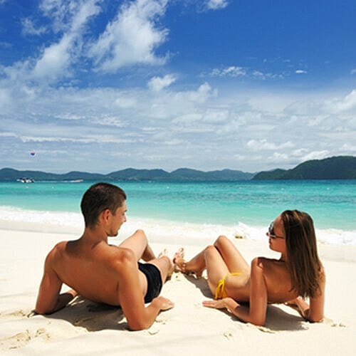 Man applying sunscreen before relaxing on the beach