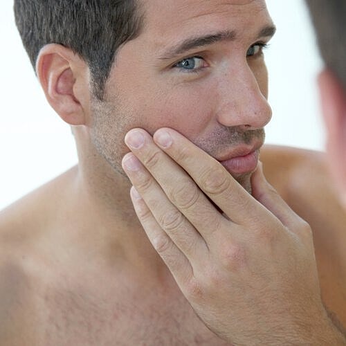 Man considering subtle dermal fillers and cosmetic treatments.