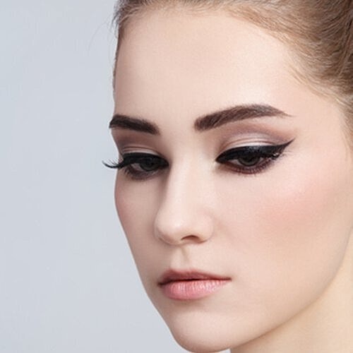 Woman wearing precise black cat eye makeup