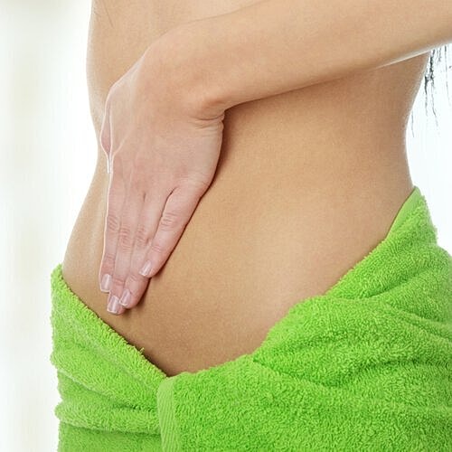 Woman measuring her waist after major weight loss