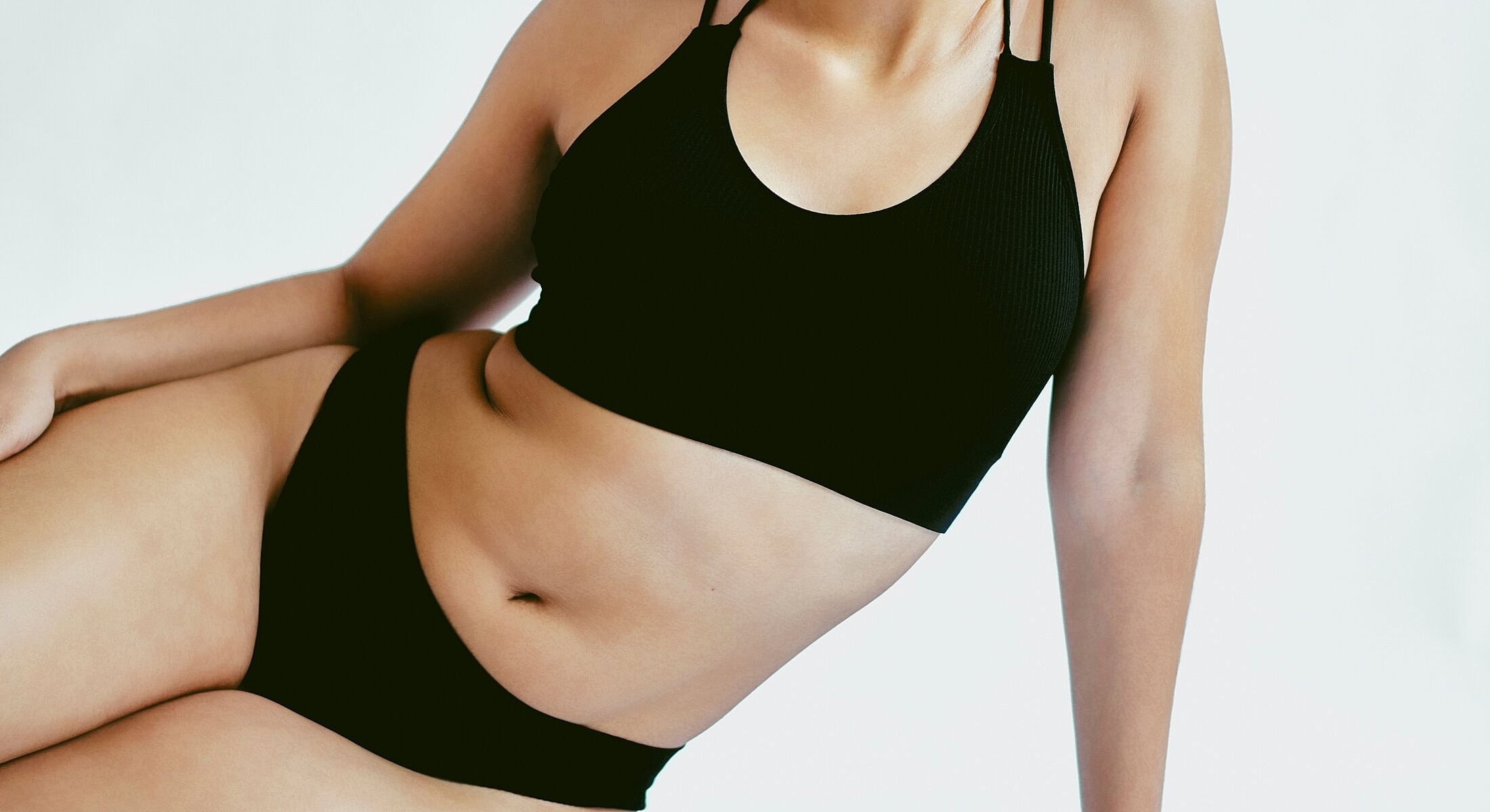 Model posing in black athletic wear.