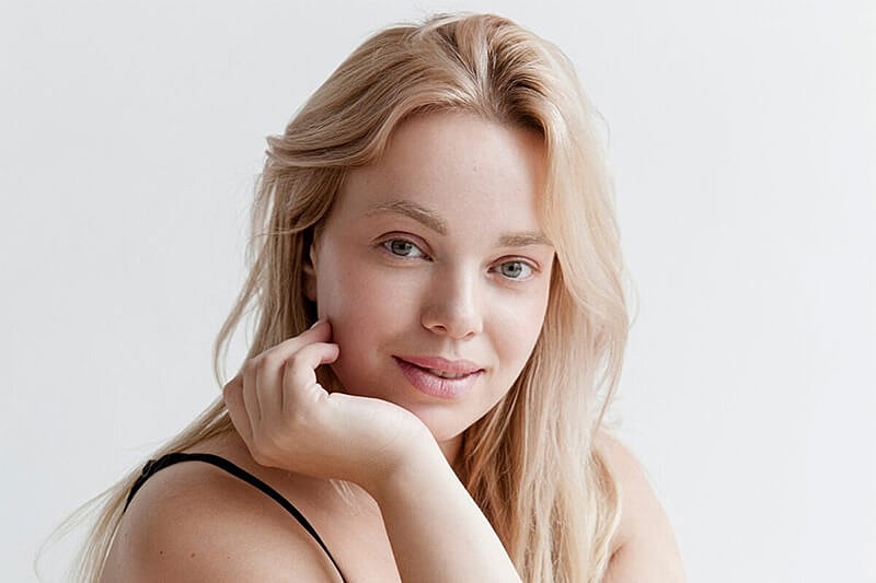 Woman celebrating weight loss with smooth skin
