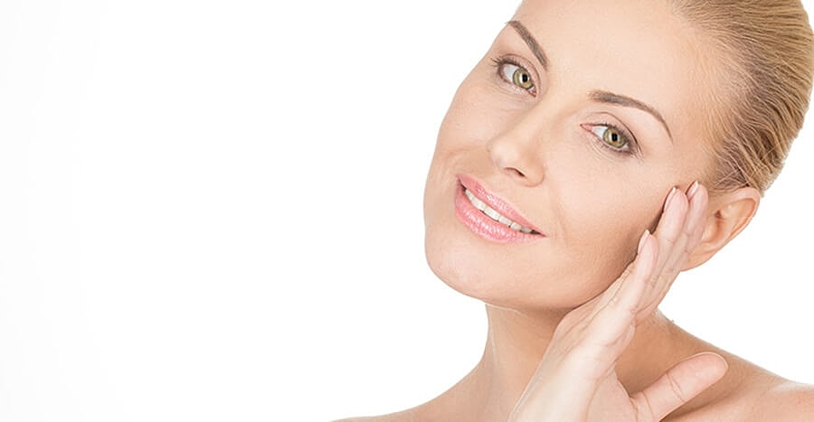 esthetician applying chemical peel to client face
