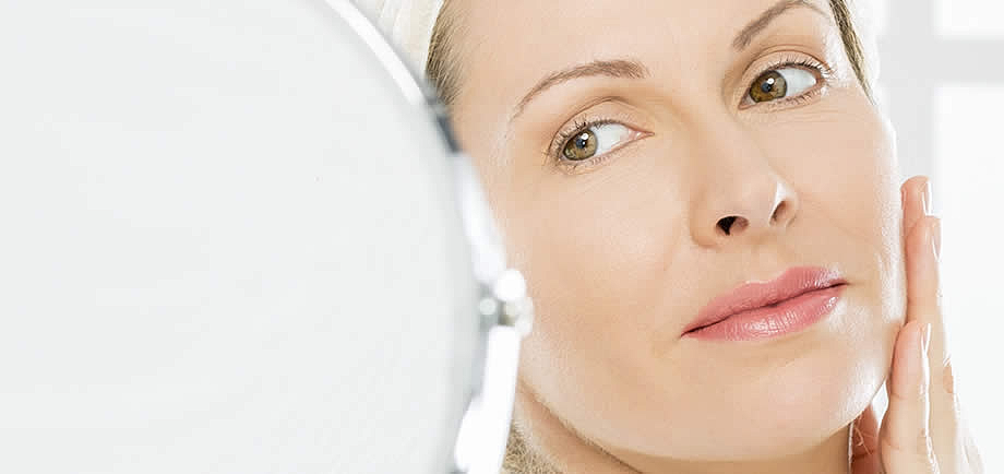 esthetician performing dermaplaning on cheek