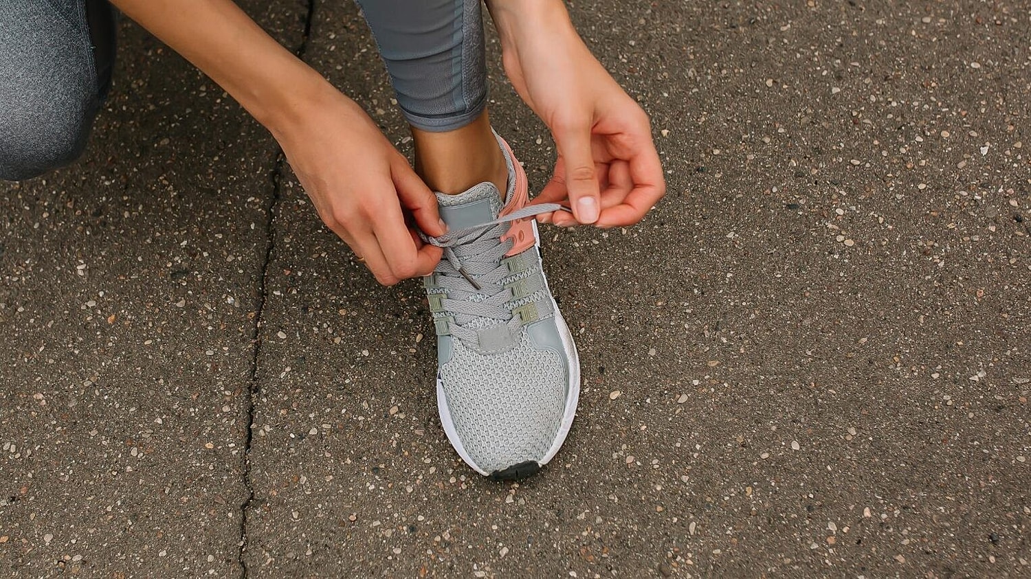 Person Tying Running Shoes