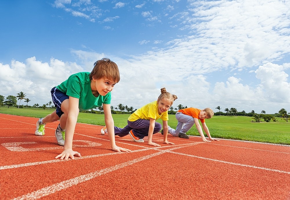kids on track at starting line ready to run