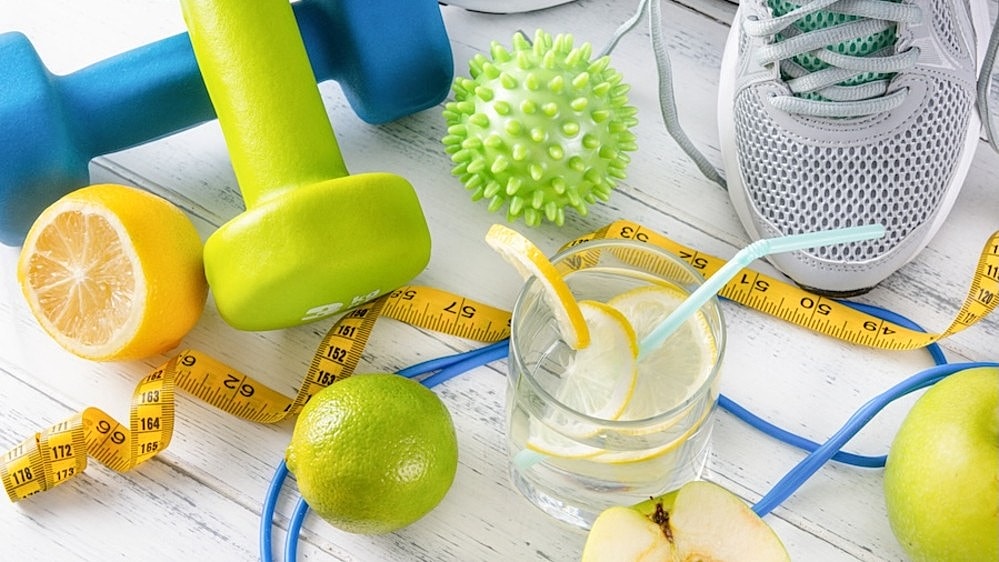 Sneakers, workout supplies, and food and https://theaspenclinic.com/schedule-your-weight-loss-appointment-in-prairieville-la/ arranged on a white wooden floor