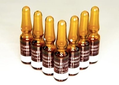 7 vials of b-12 injections on a white table