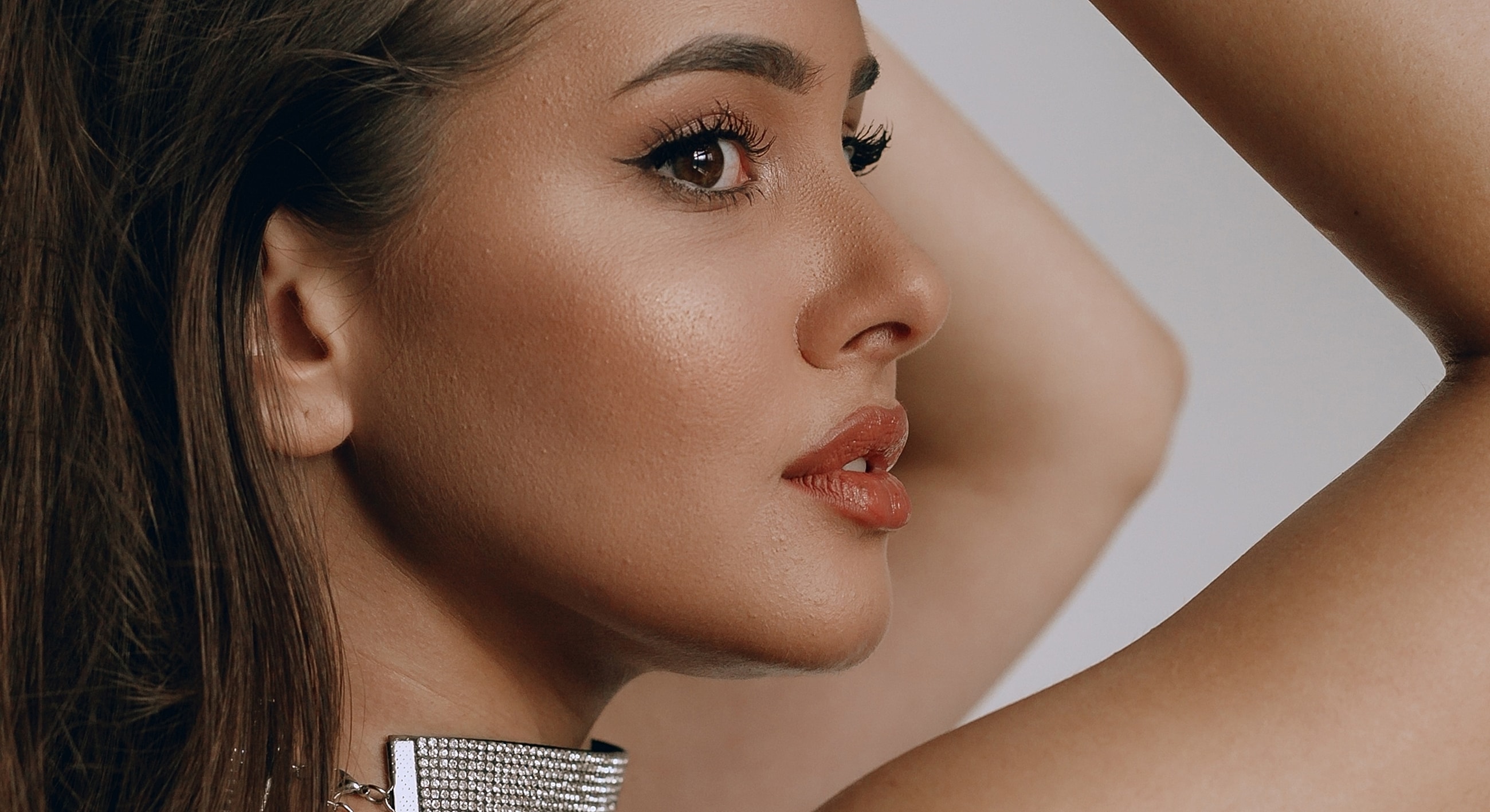 Profile portrait of a woman with elegant makeup.