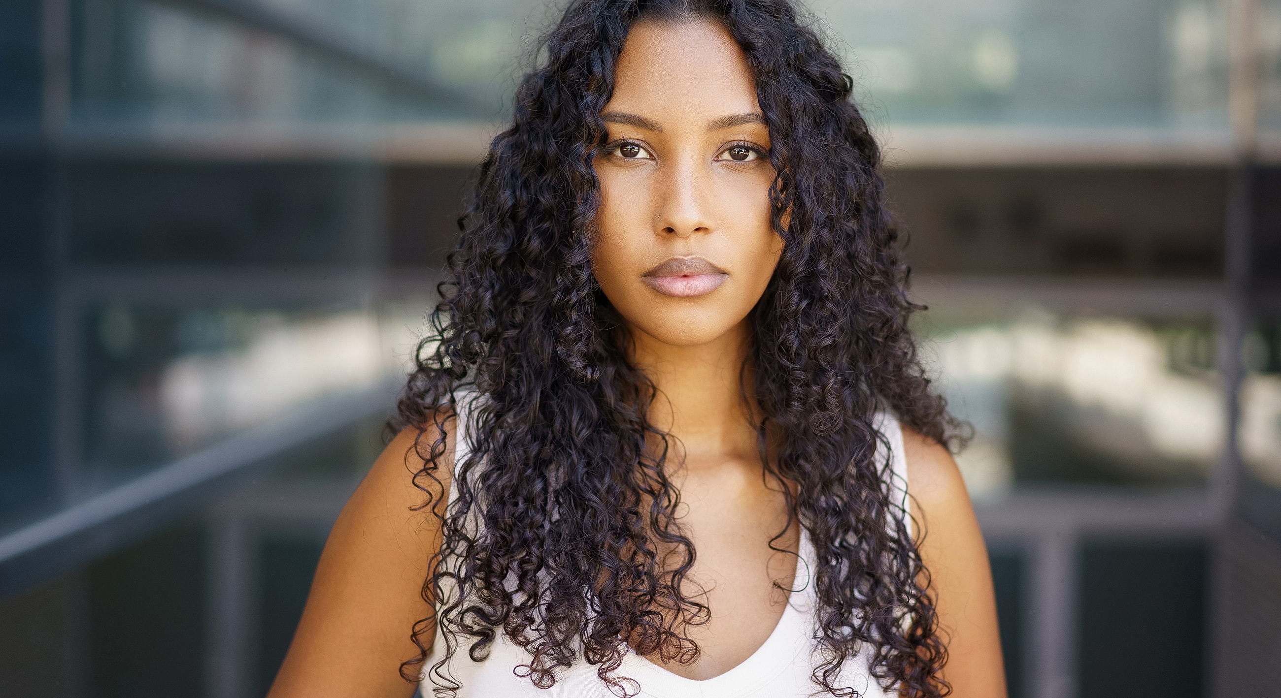 Portrait of a woman with curly hair.