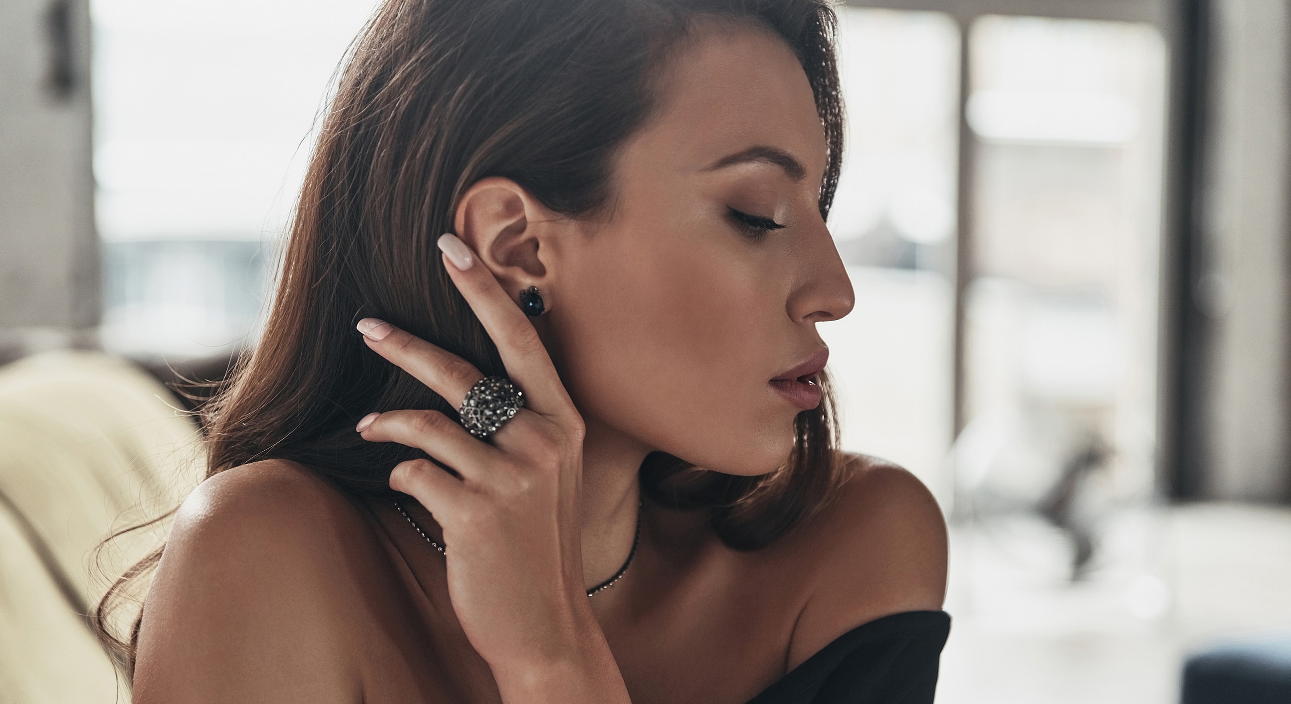 Woman wearing elegant jewelry, profile view.