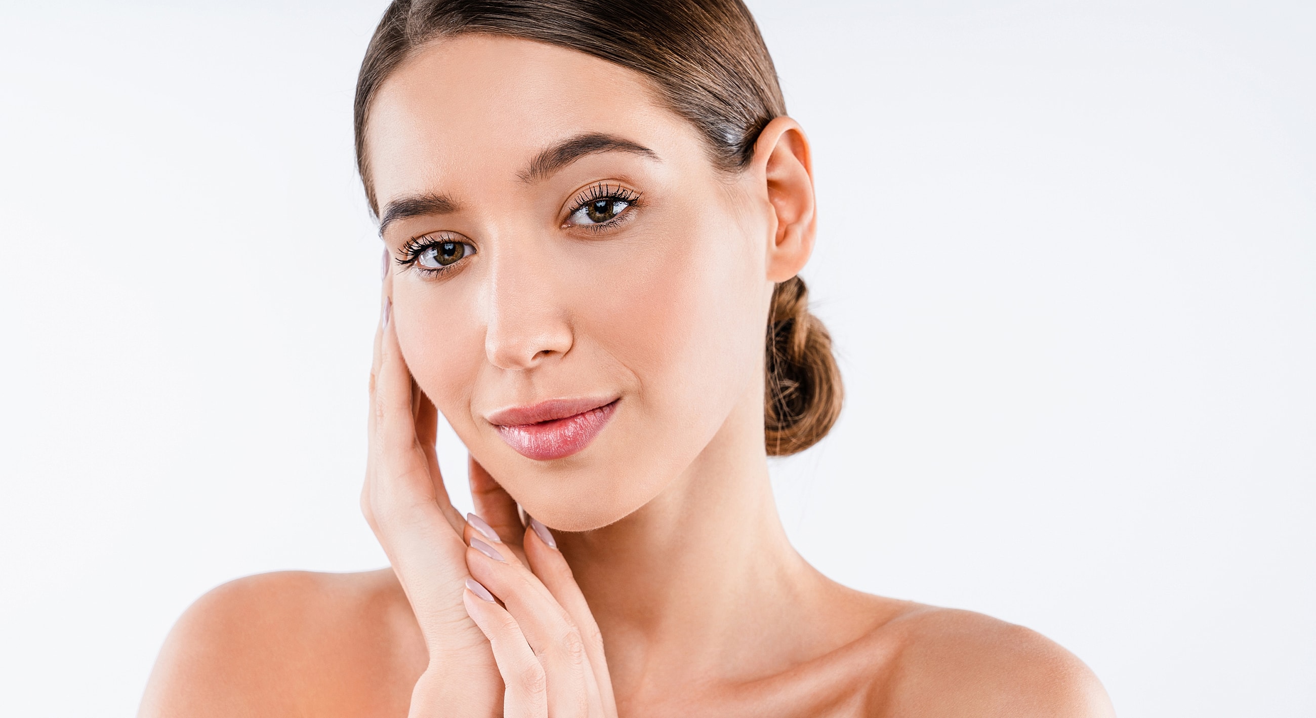 Woman gently touching her face, natural beauty.