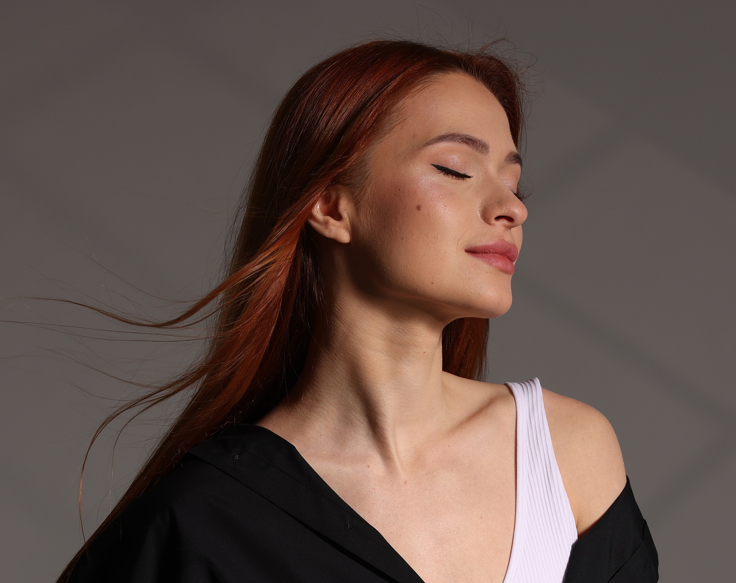 Woman with flowing red hair in soft lighting