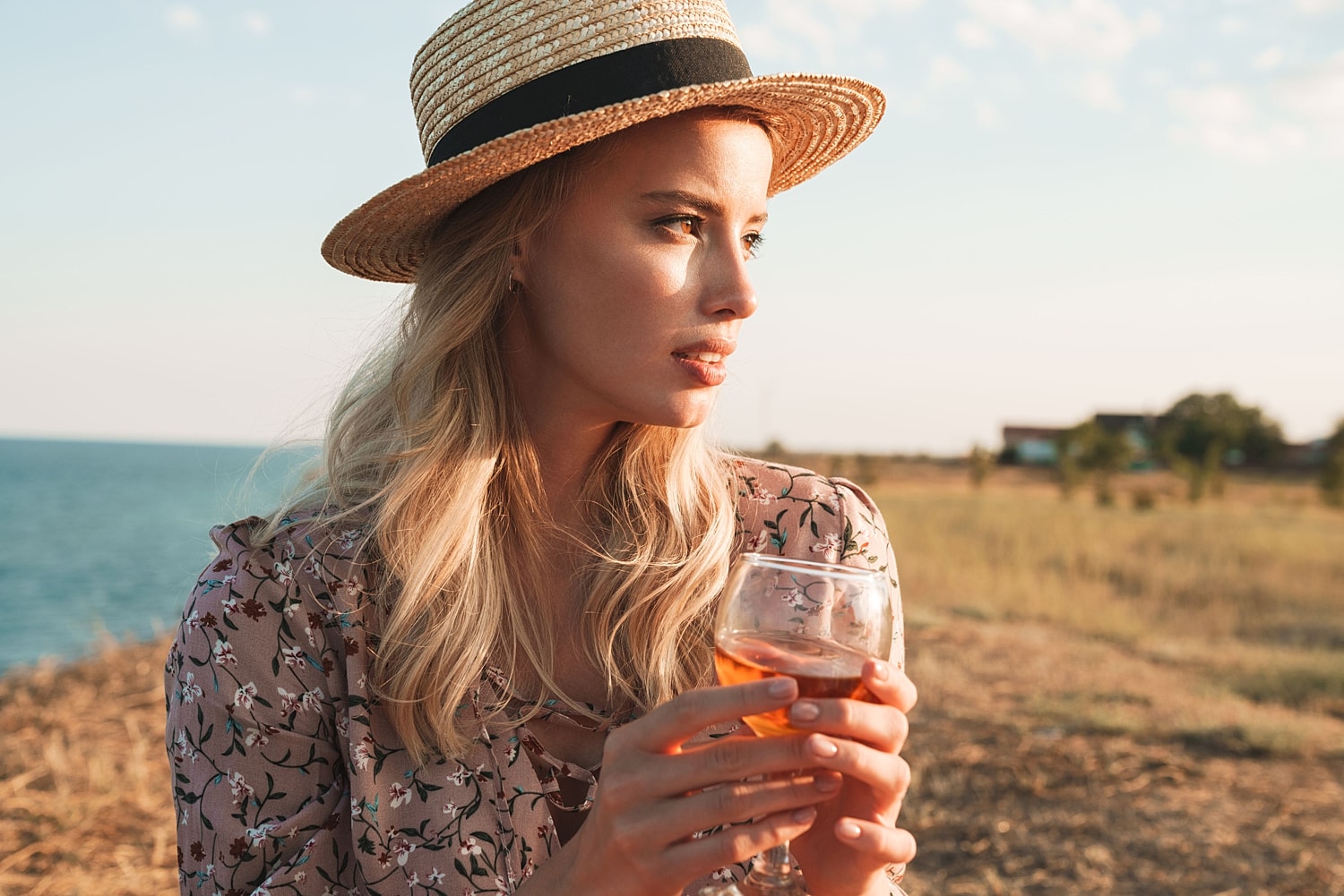 Woman enjoying a drink outdoors, illustrating GLP-1 weight loss support and managing food noise before the holidays.