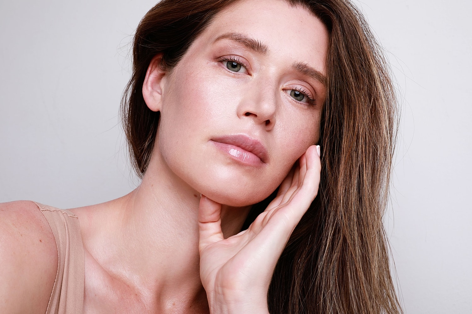 A woman with clear, glowing skin and a dewy complexion after a professional Hydrafacial treatment.