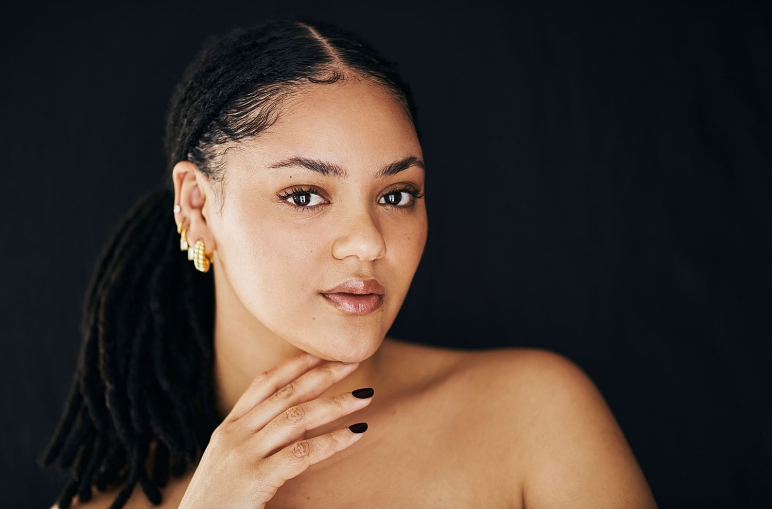 A woman examining her smooth skin in a mirror after a Morpheus8 treatment, showcasing the improved skin texture and "glow" that develops during the cellular repair phase.