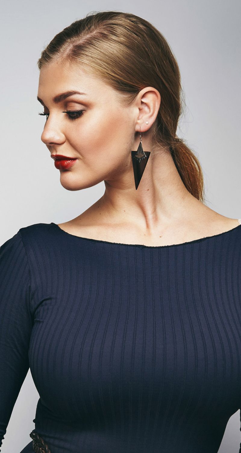 med spa patient model showcasing elegant attire and statement earrings.