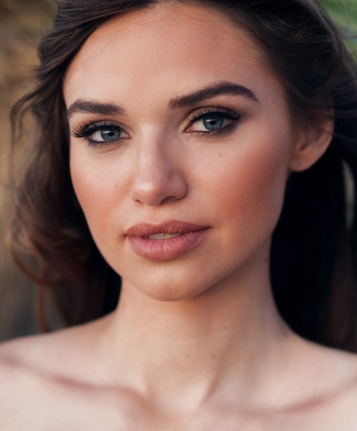 Smiling laser skin resurfacing patient model with natural makeup and necklace.