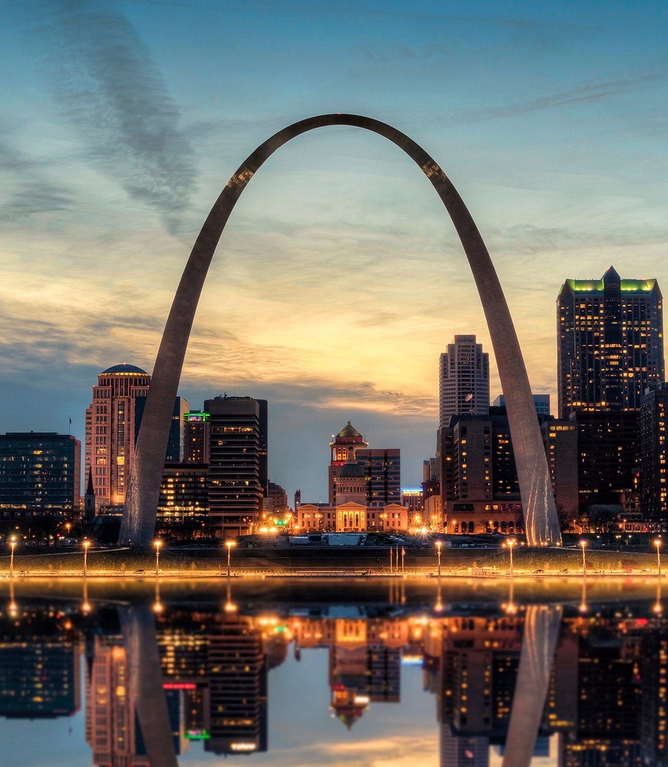 St. Louis skyline with Gateway Arch at sunset.