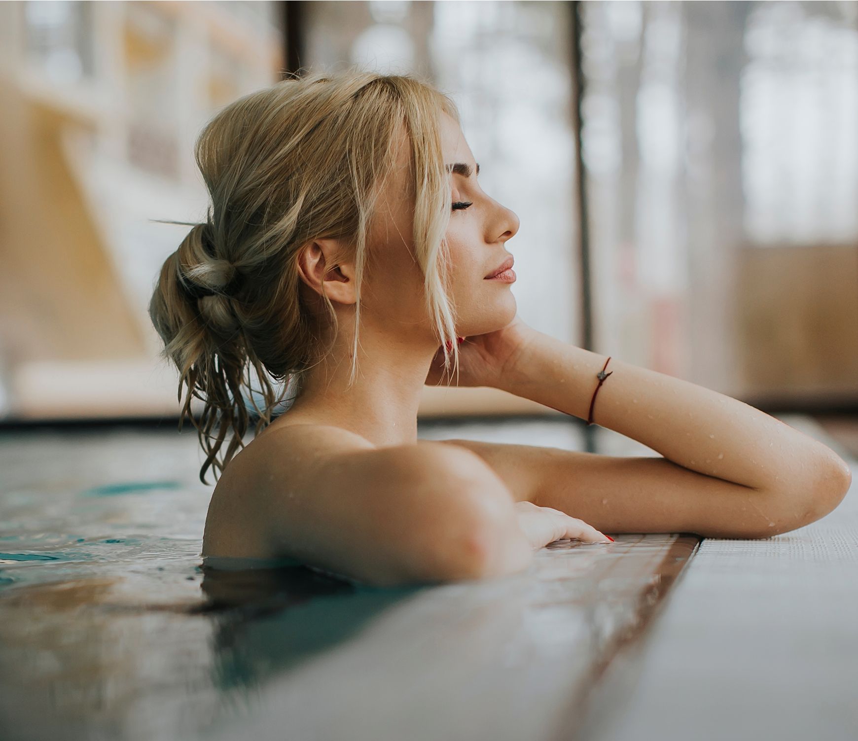 med spa patient model relaxing in a pool, serene expression.
