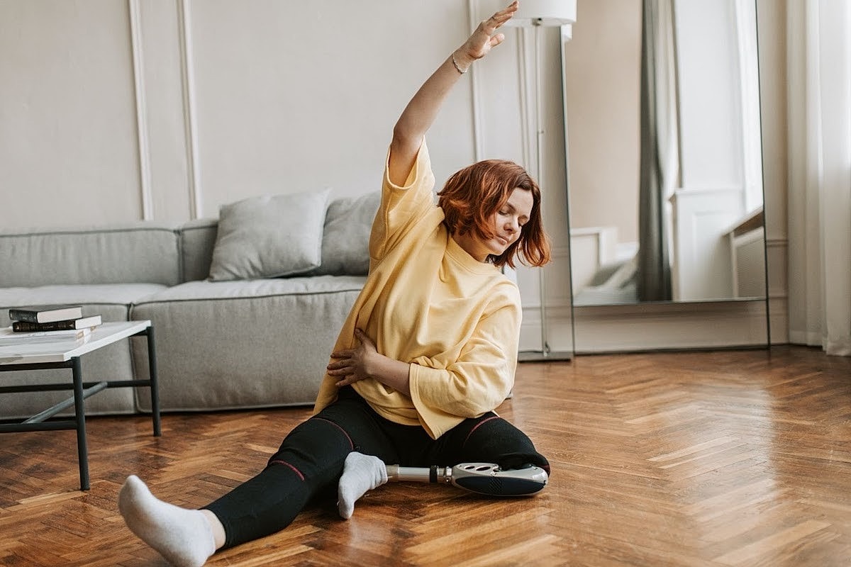Woman performing yoga in her living room