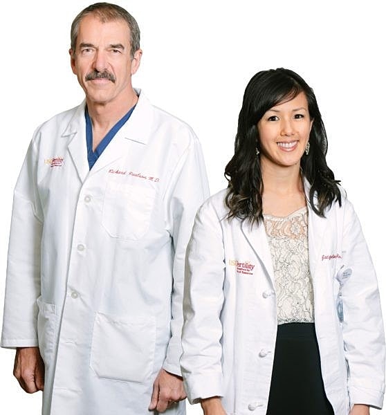 Doctors in white lab coats standing together.