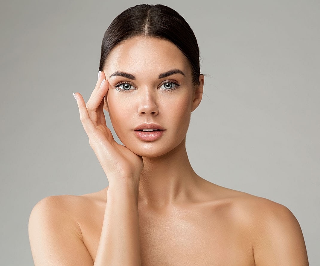 Woman with flawless skin highlighting results of RF microneedling.
