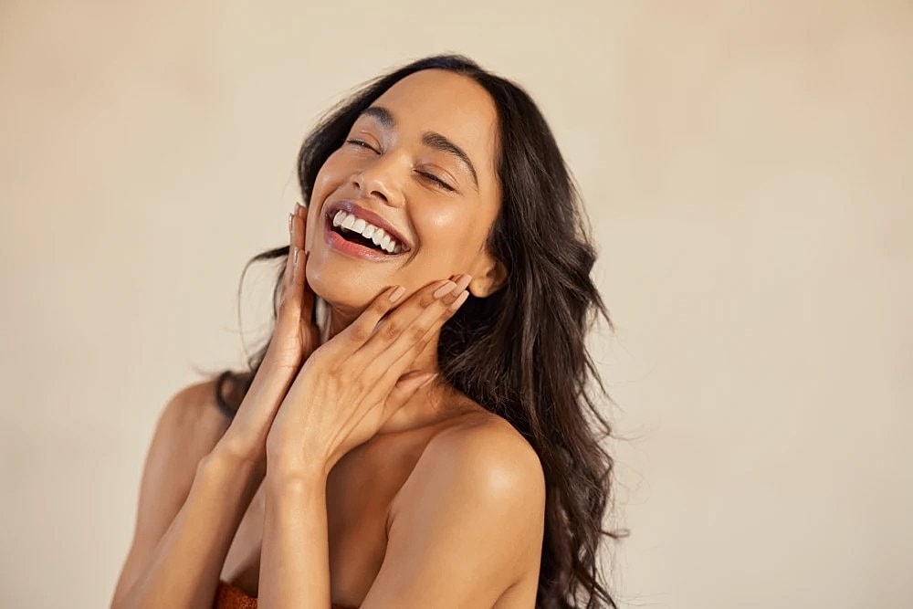 Radiant woman after a med spa facial treatment.