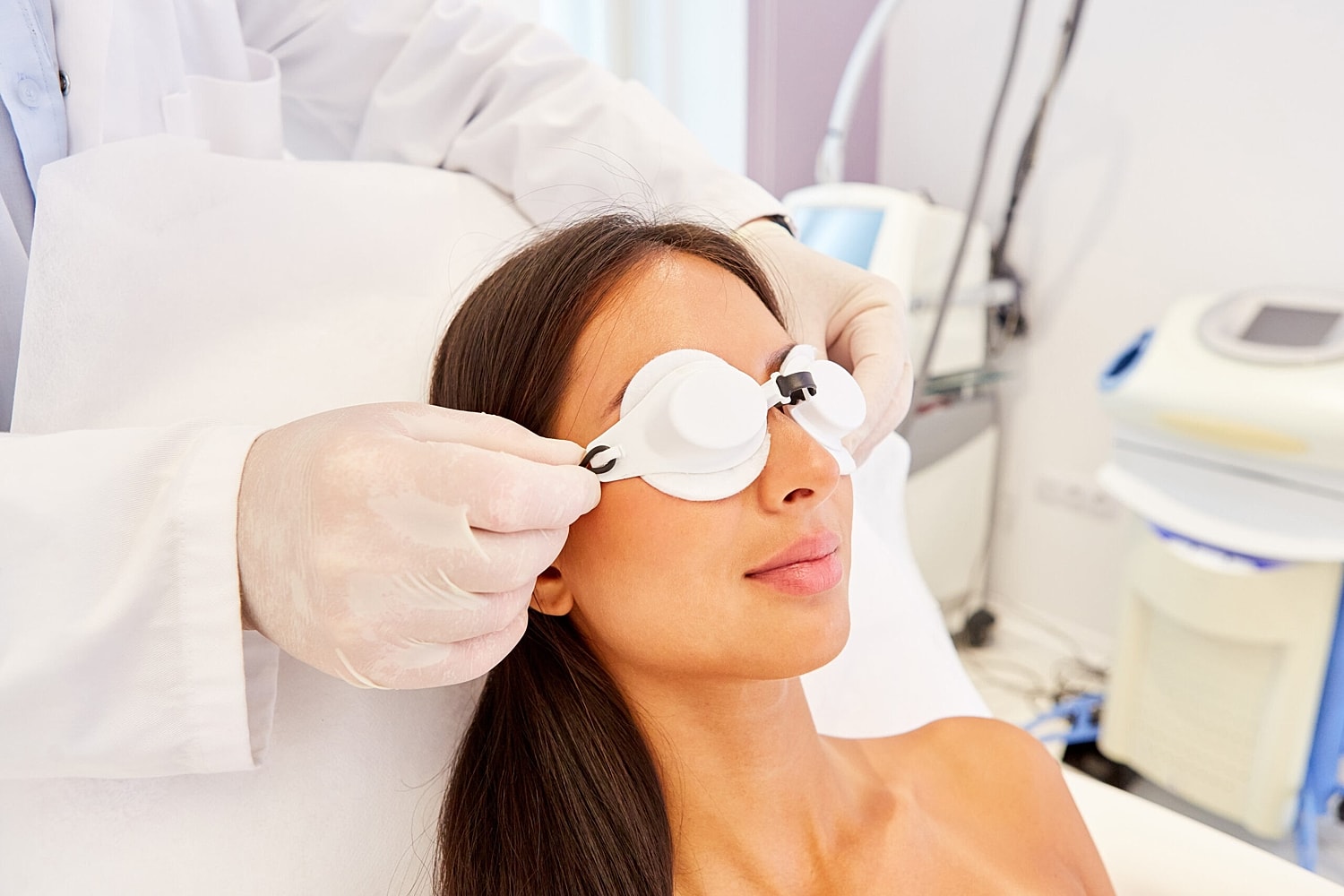 A patient prepares for a laser skin resurfacing procedure with protective eye shields.