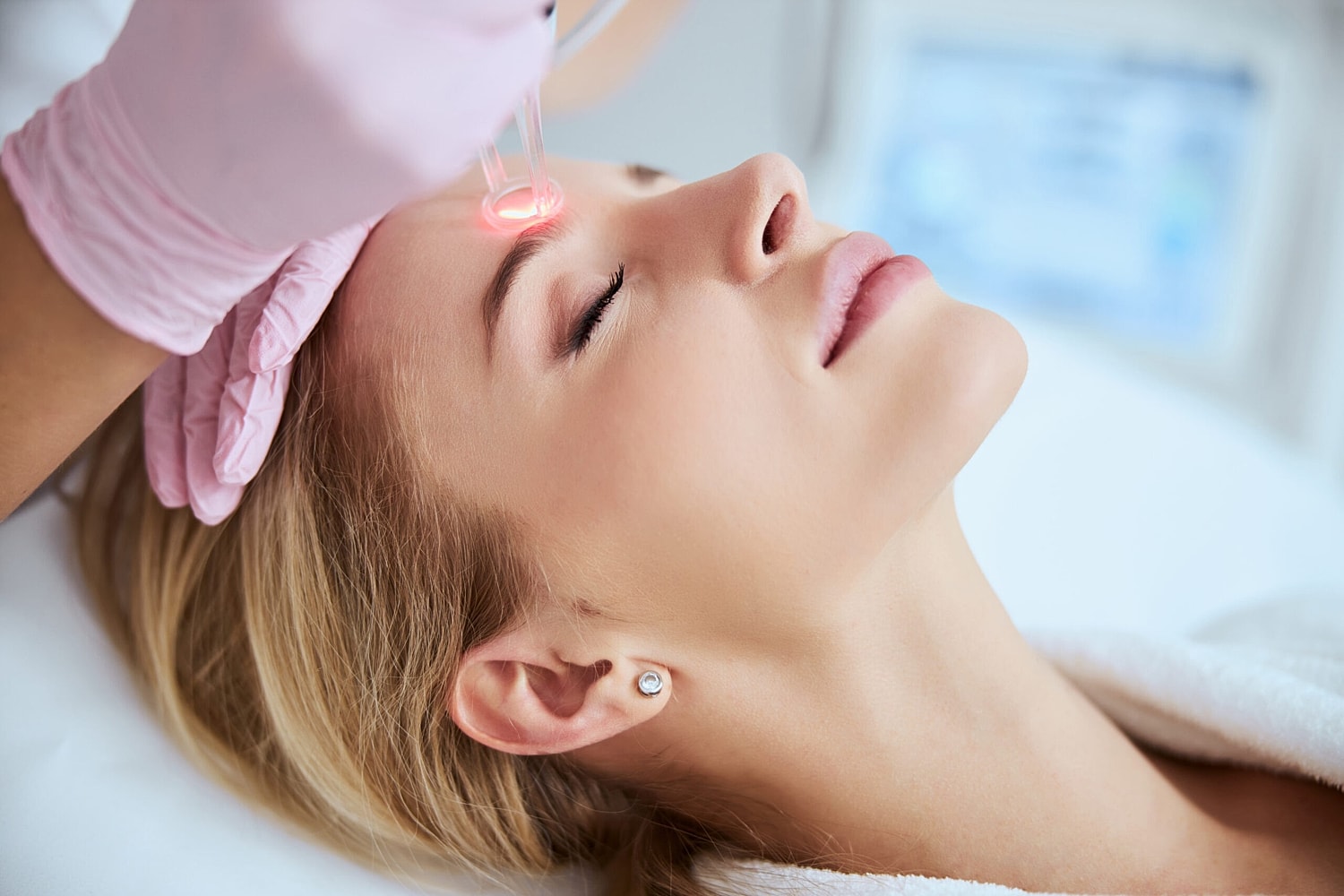 A professional performs a laser skin resurfacing session to enhance skin texture and reduce fine lines.