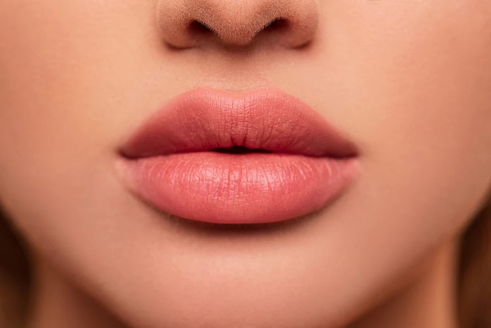 Close-up of full, smooth lips enhanced by lip fillers.