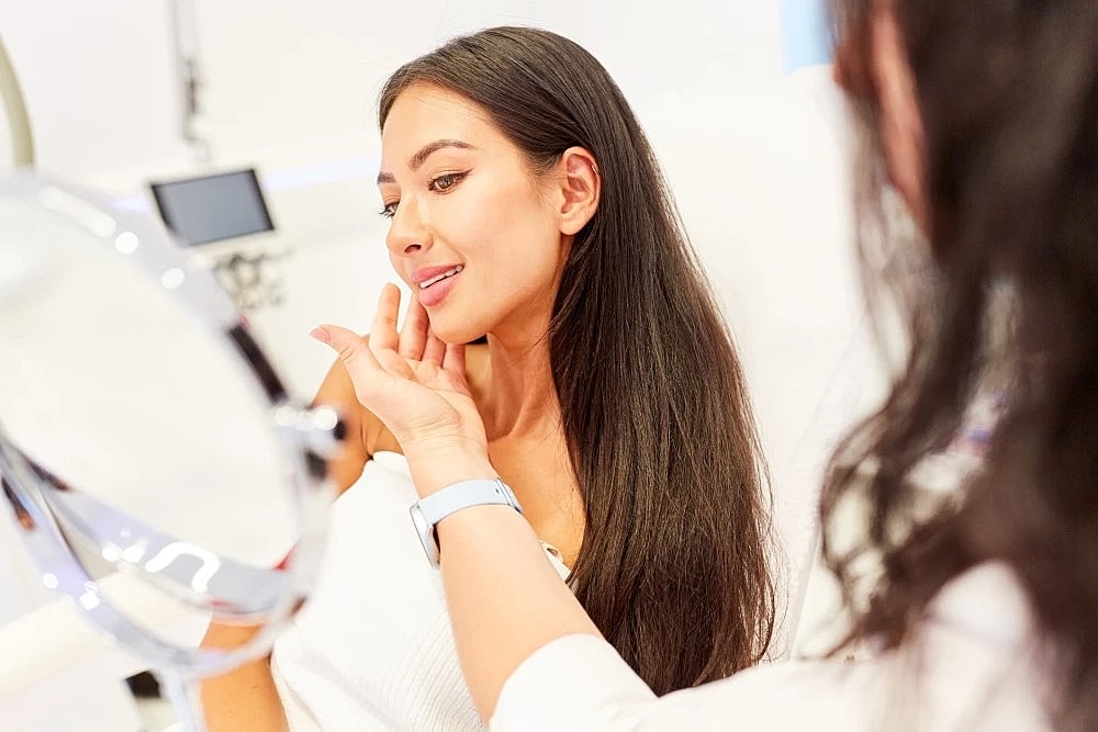 Woman in consultation discussing Morpheus8 treatment.
