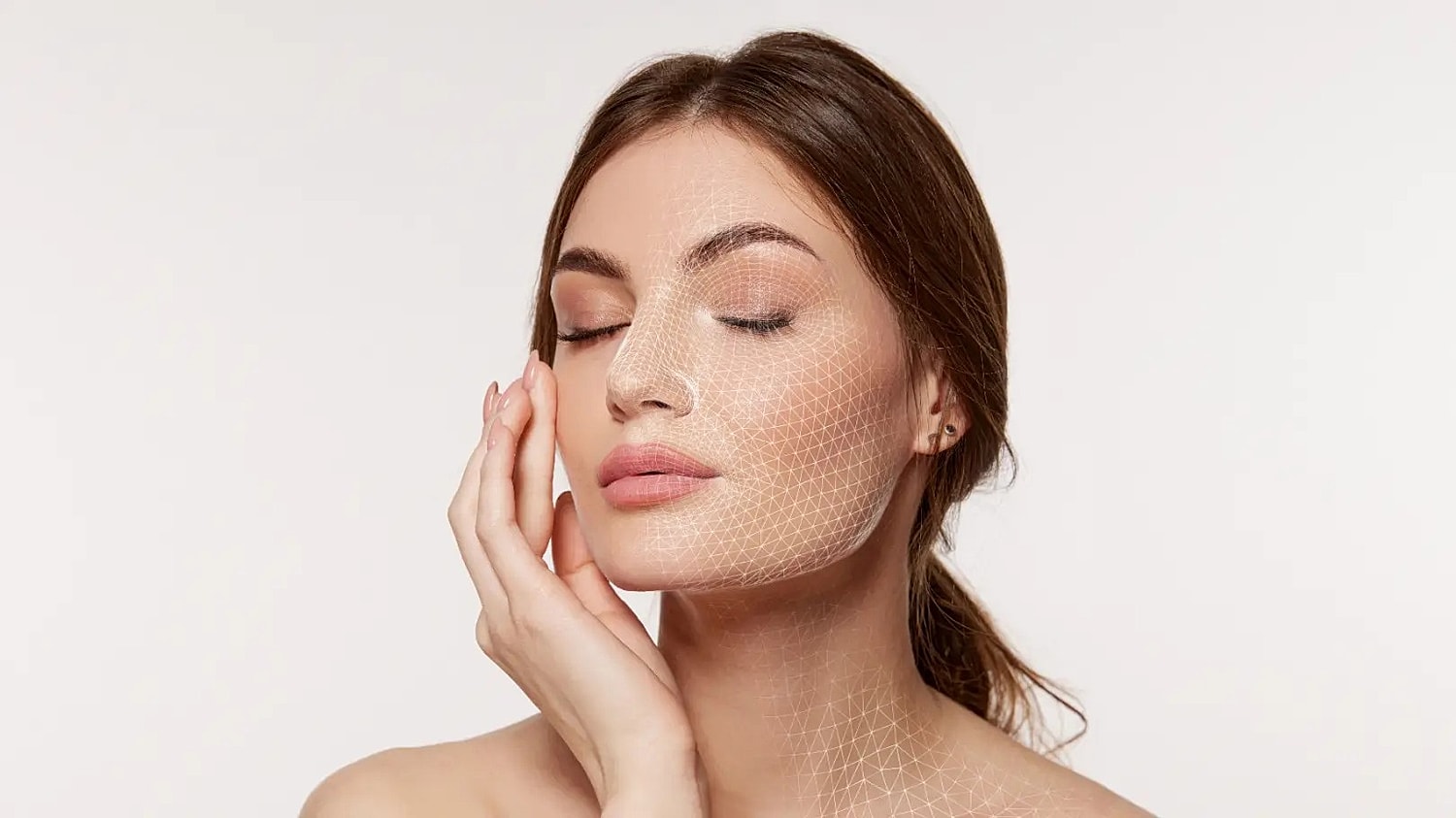 Woman with closed eyes touching her cheek with a white geometric mesh overlay across her face and neck.