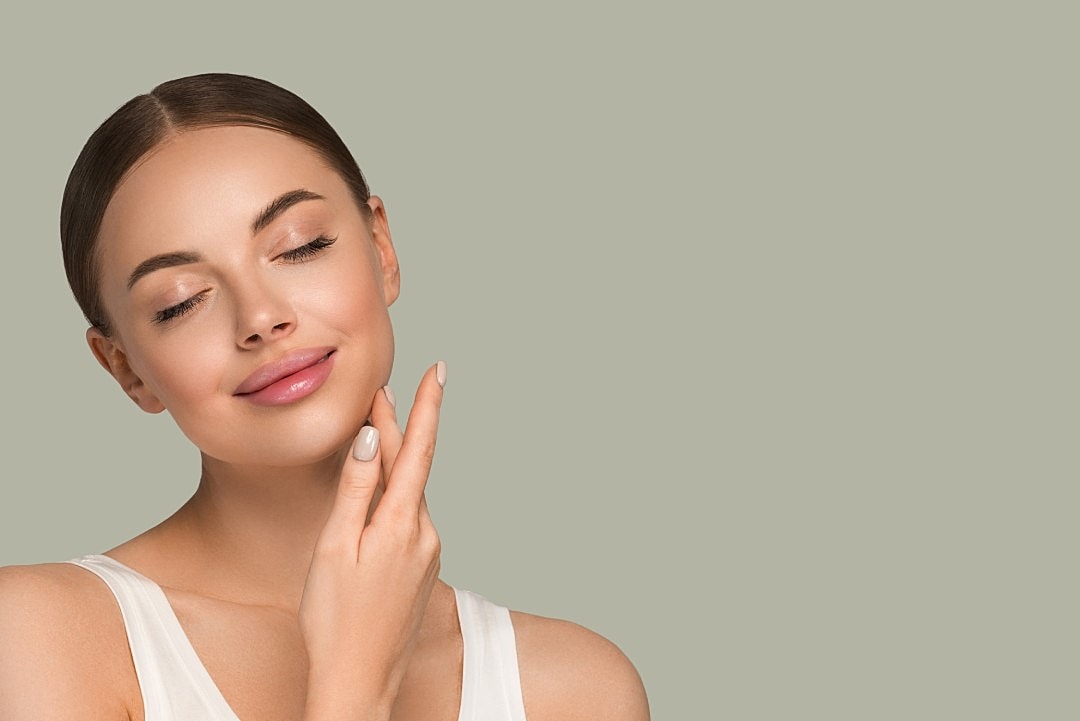 A woman with radiant, youthful skin after a Sculptra treatment.