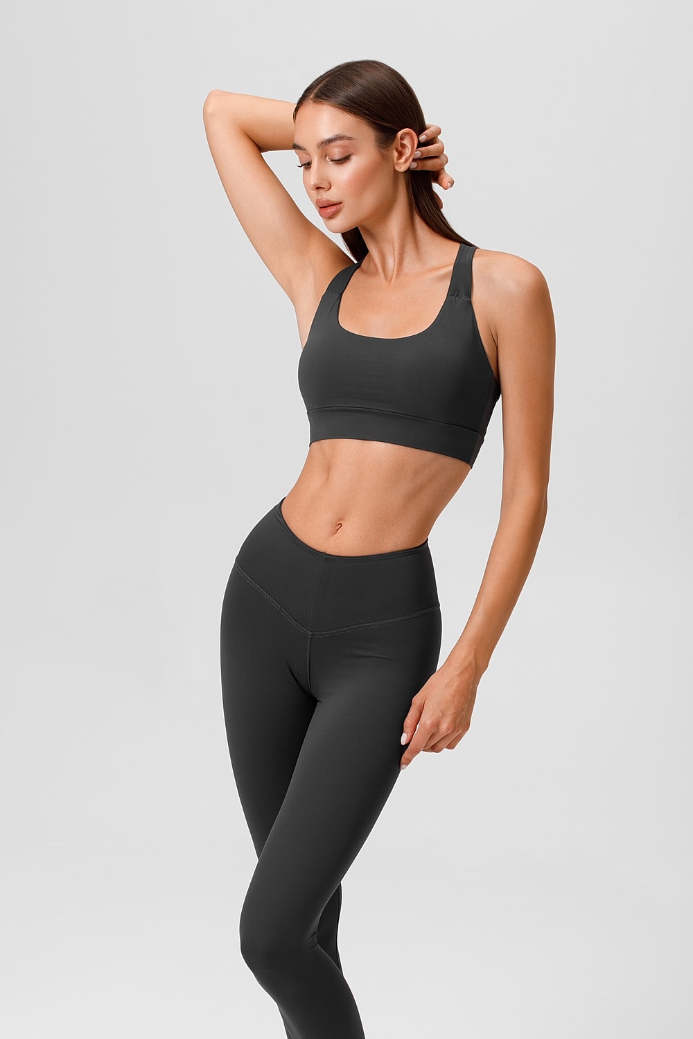 Woman in athletic wear posing confidently.