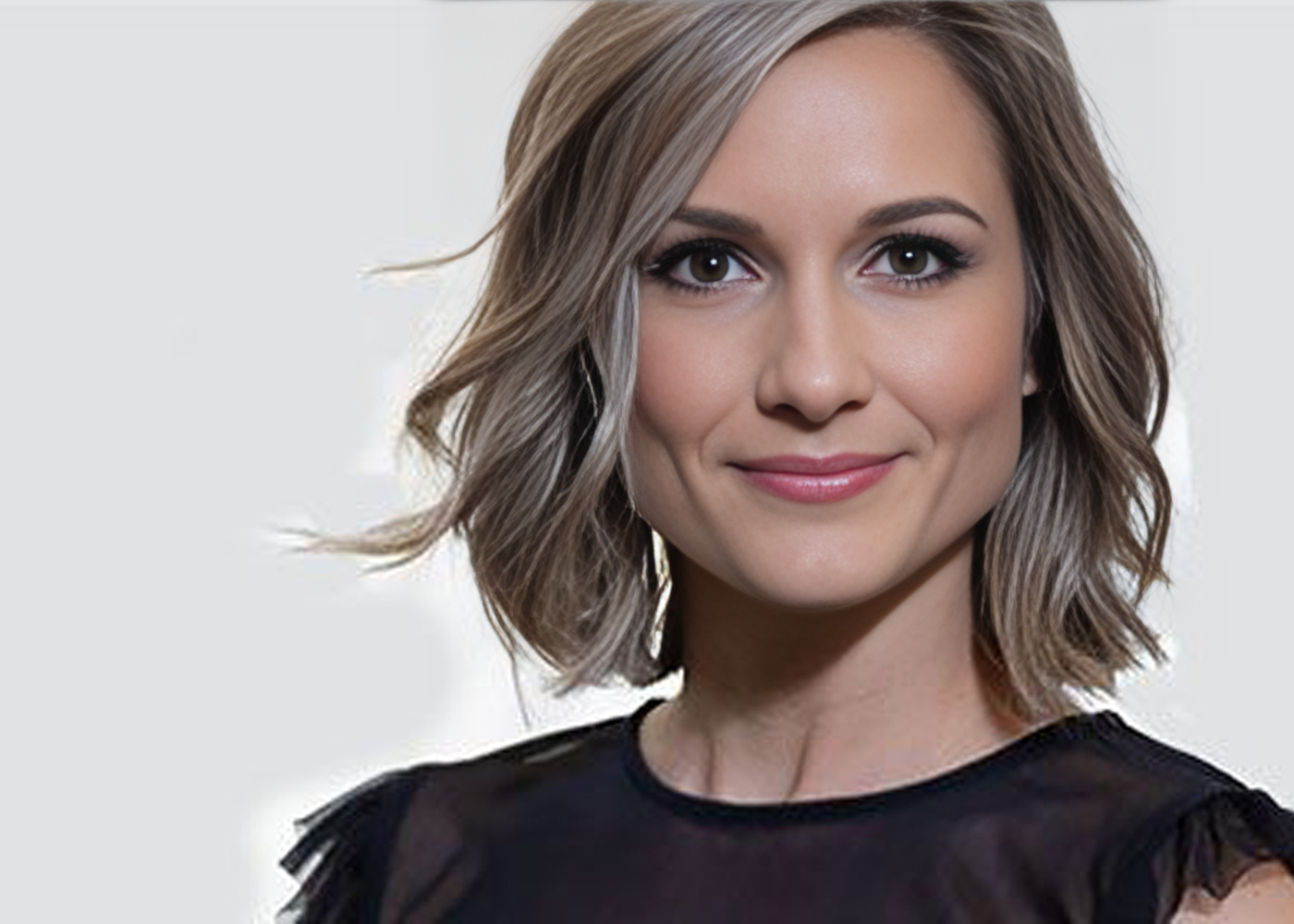 Smiling woman with short, wavy hair.