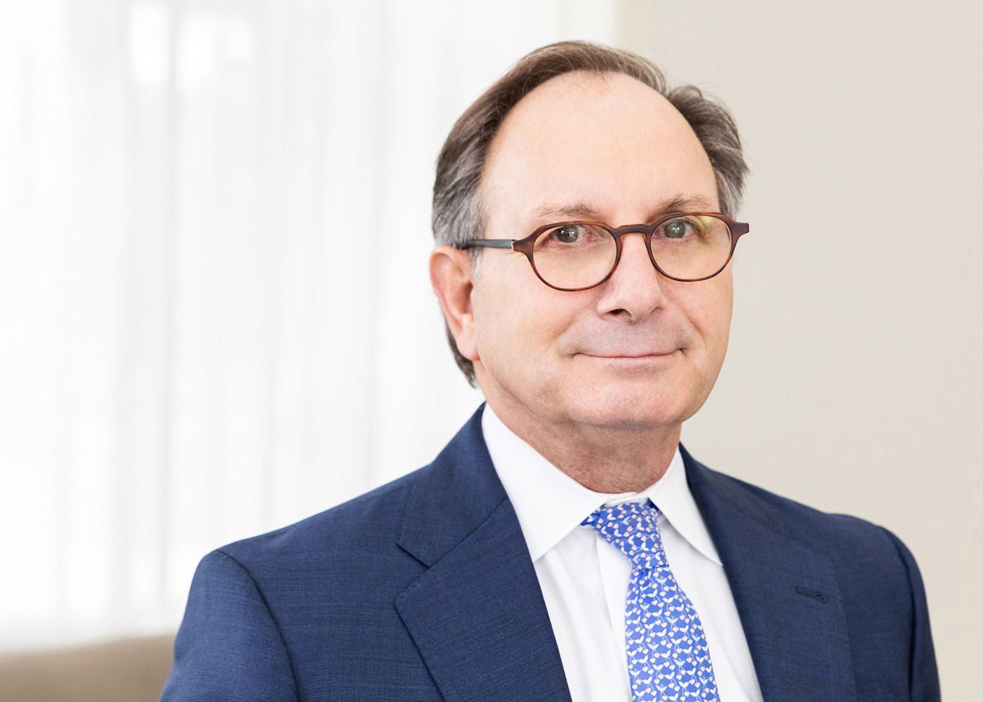 Professional man in a suit with glasses.