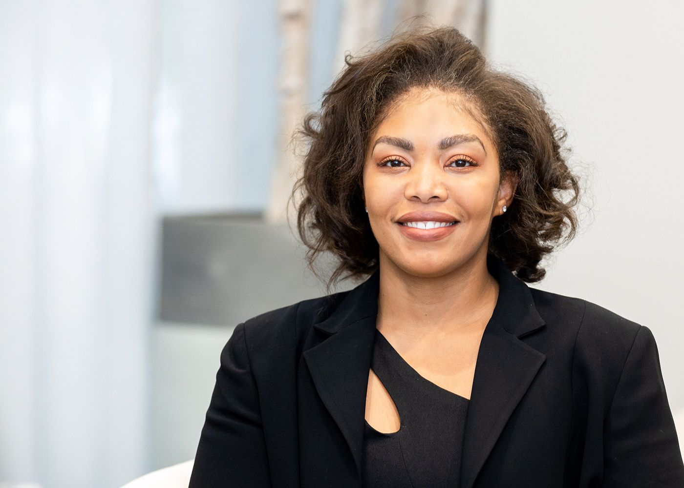 Professional woman smiling in business attire.