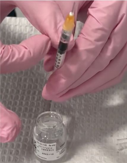 Preparing a syringe with medication.
