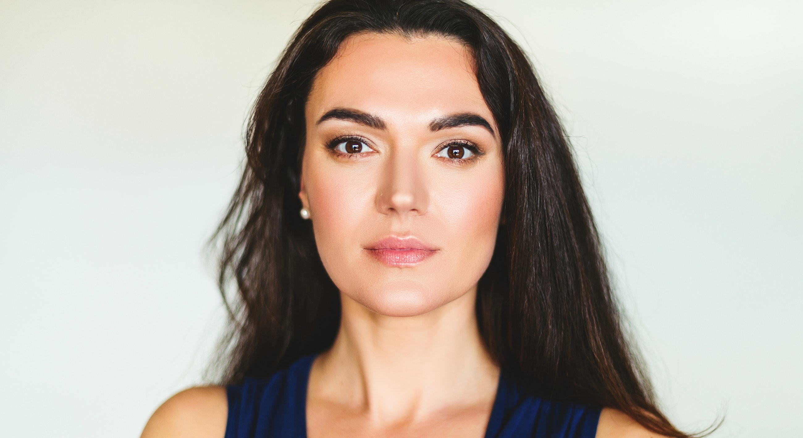 Woman with long dark hair and natural makeup.