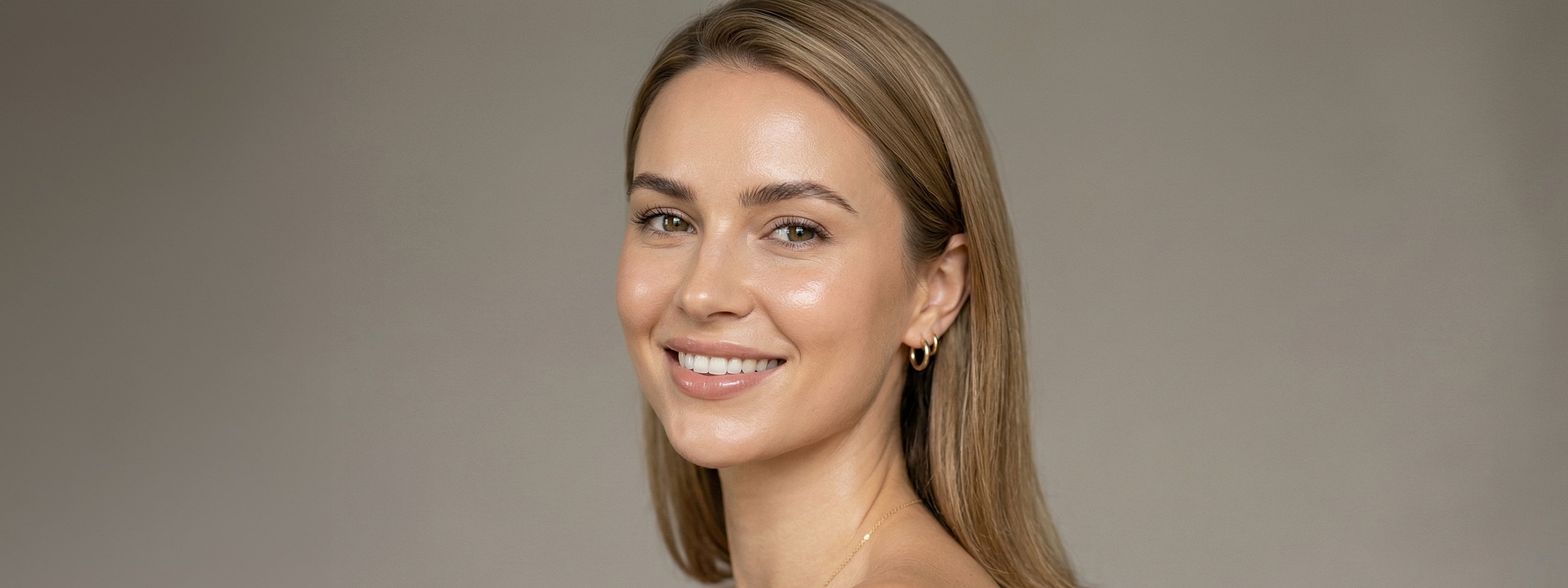 Smiling woman with long, straight hair.