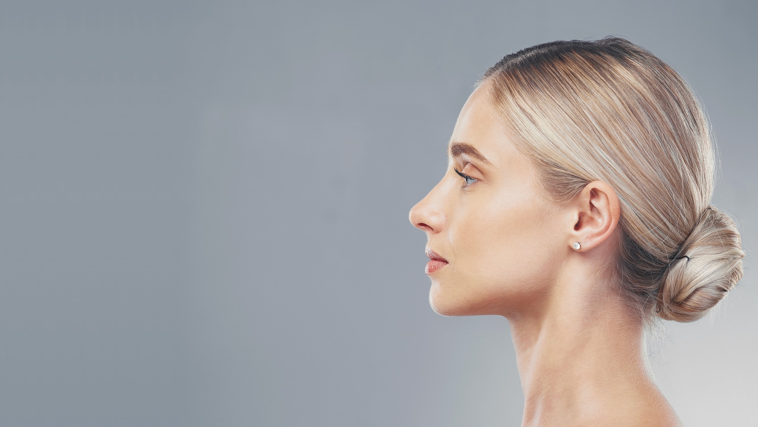 Profile of a woman with sleek hairstyle.