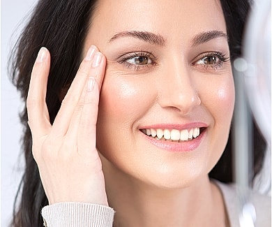Aesthetician performing treatment in skincare clinic.