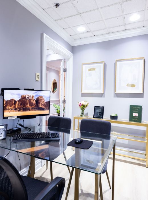 Modern office workspace with computer and decor.