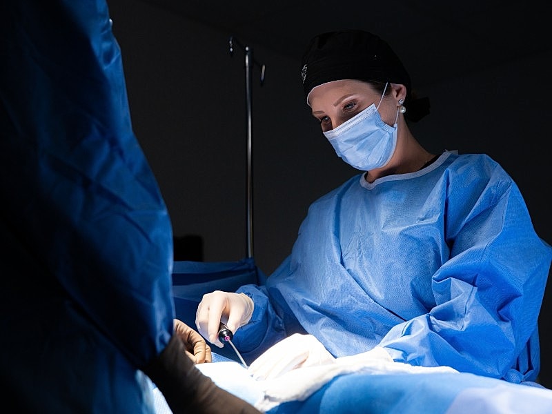 Surgeon performing surgery in operating room
