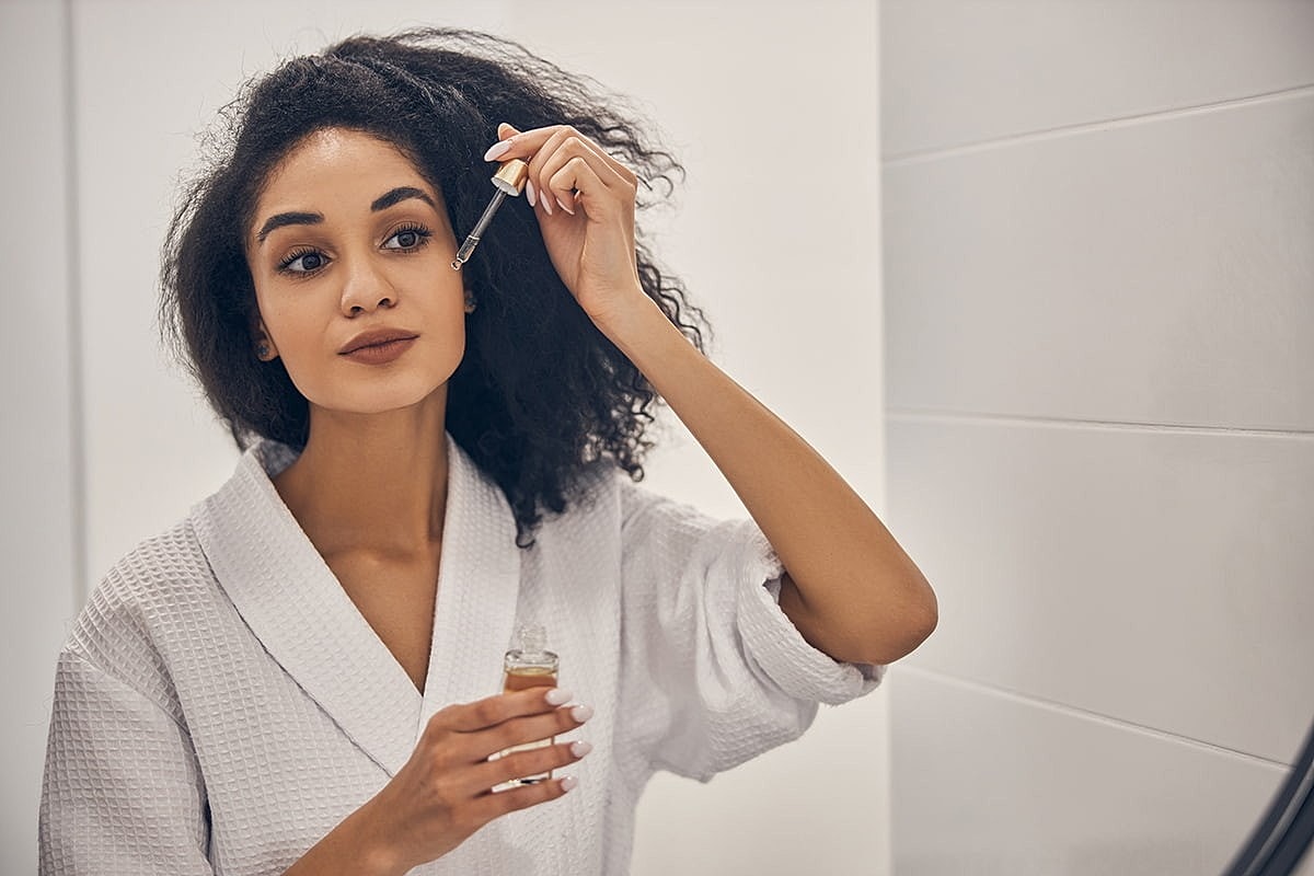 houston plastic surgery model applying serum to her face